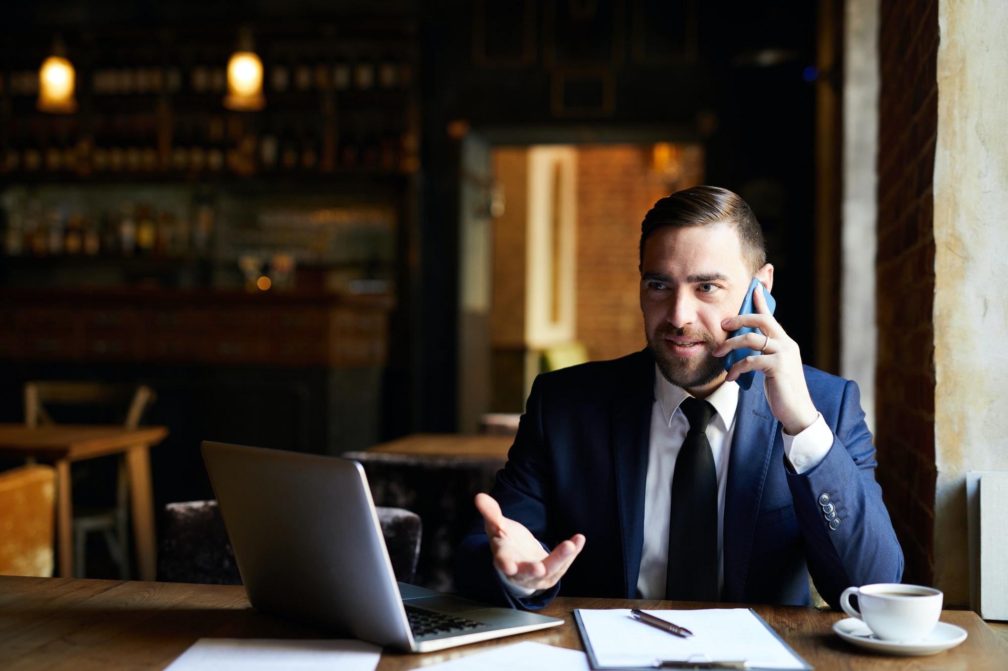 Businessman solving work issues on phone