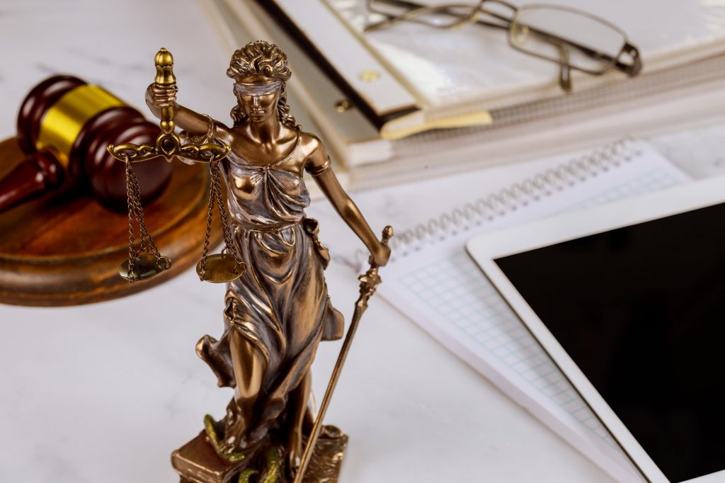 The Statue of Justice symbol, legal law office on a digital tablet of lawyers professional of Judge